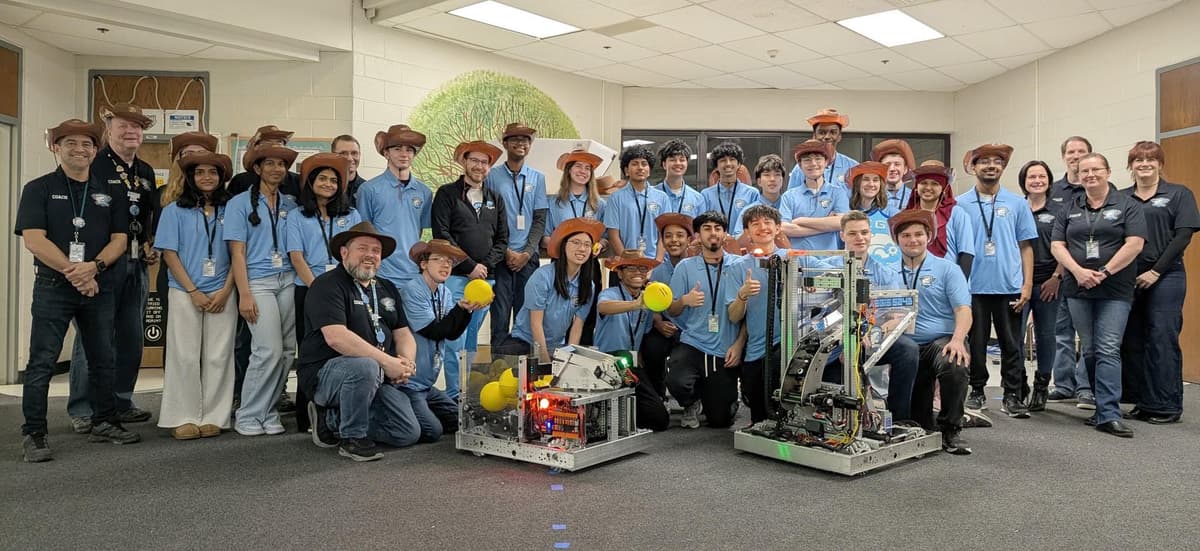 Team photo with robotics display